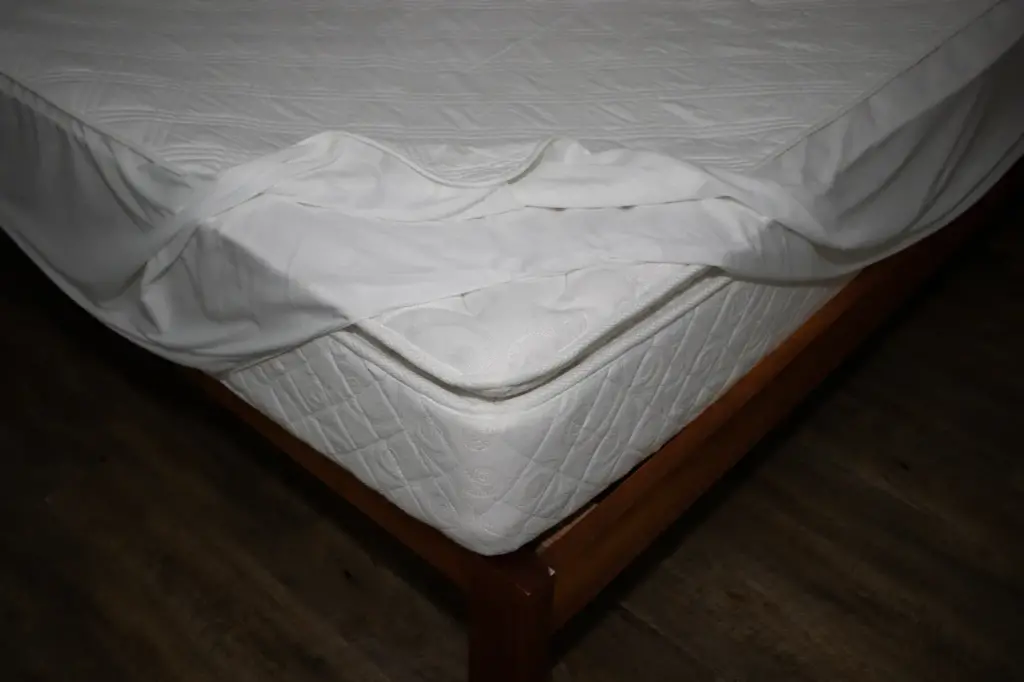 Fitted Mattress Protector being Added to Mattress