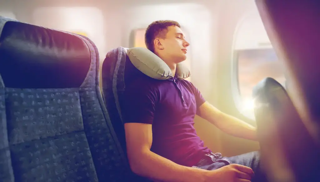 Man Sleeping Inside The Plane With A Travel Pillow, How to Fall Asleep On a Plane?