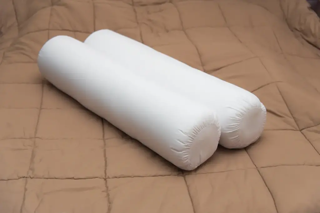 Pair of Bolster on a Brown Blanket 