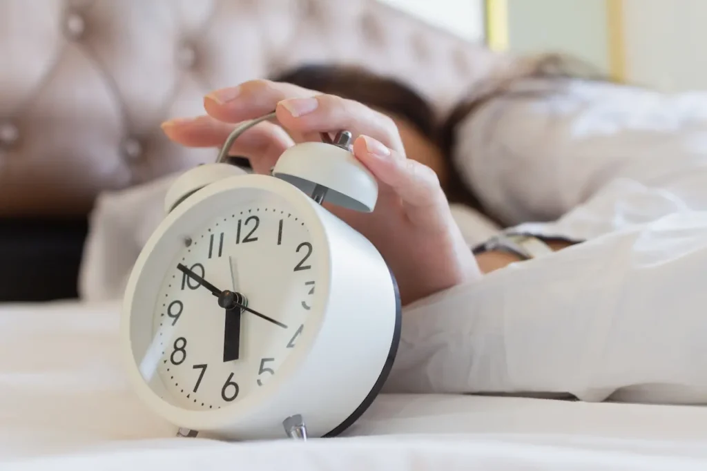 Woman Holding Vintage Style Alarm Clocks 