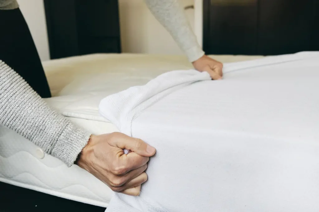 Man Covering a Mattress with a Mattress Protector