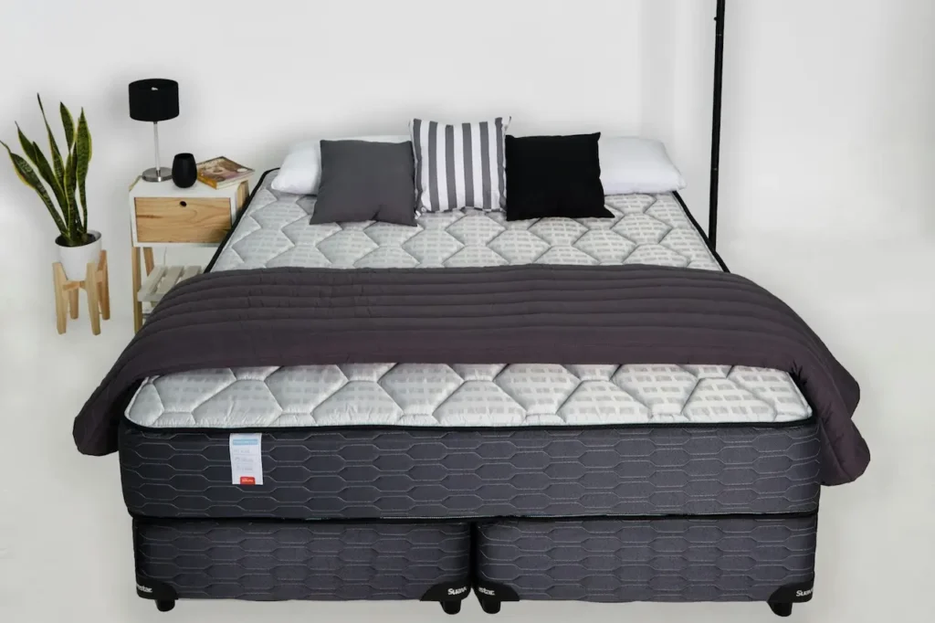 A Bed with Mattress, Pillows, and Blanket