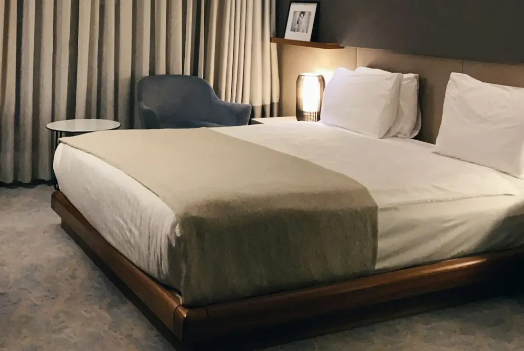 A Bed with a White Sheet and Pillows 