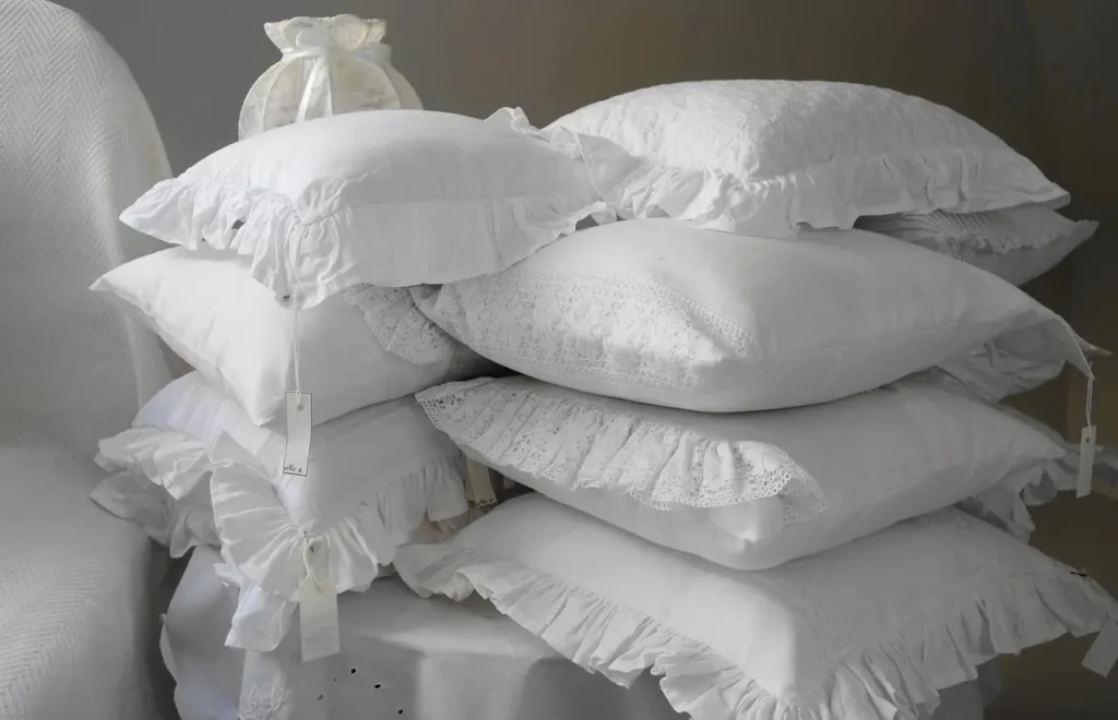 A Collection of White Pillows Piled Together 