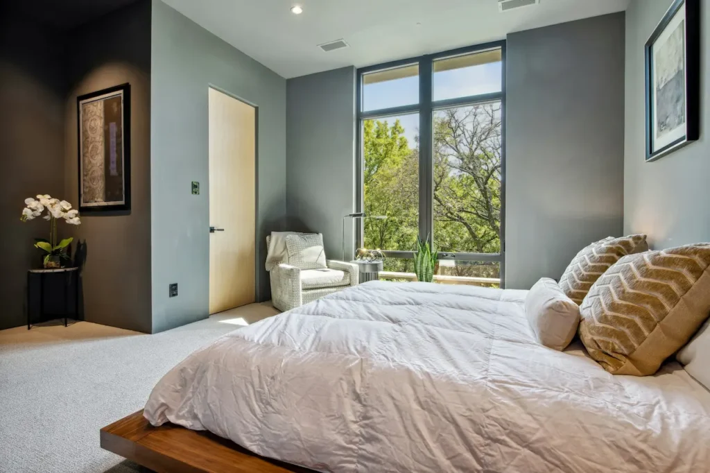 A White Bedroom with a Large Window 