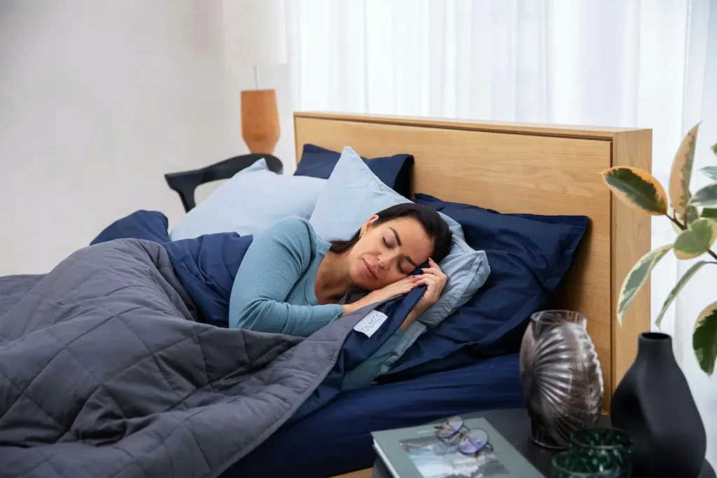 A Woman is Sleeping on a Blue Bed 