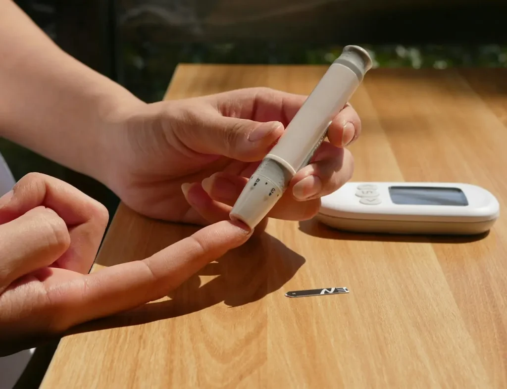 Person Checking their Blood Sugar with a Lancet 