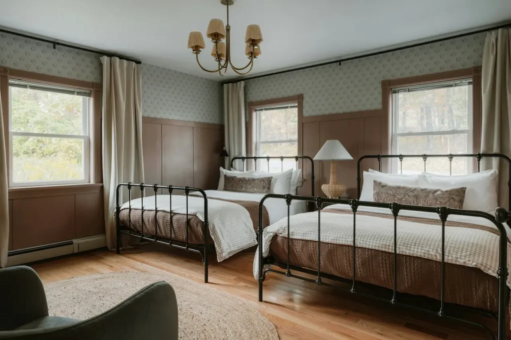 Two Beds in a Rustic Bedroom with Windows