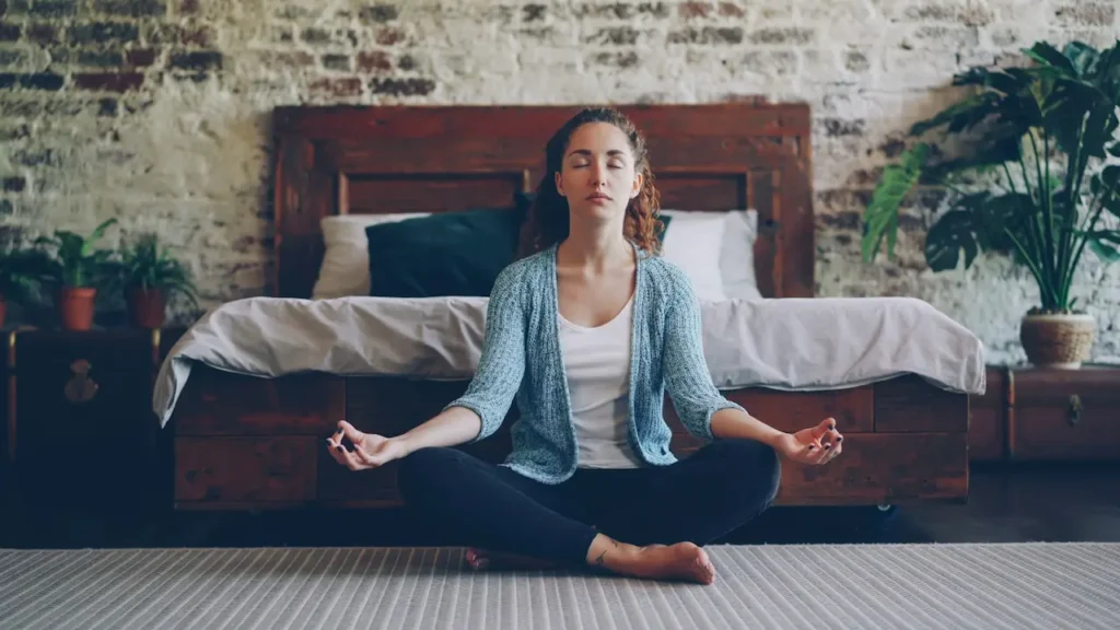 Woman Meditating Peacefully in Her Bedroom 